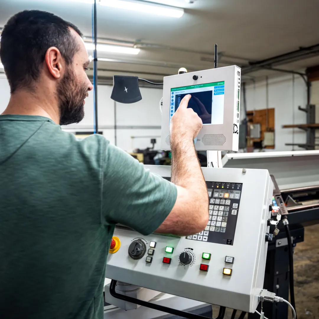 Manufacturing team reviewing real-time equipment monitoring dashboard