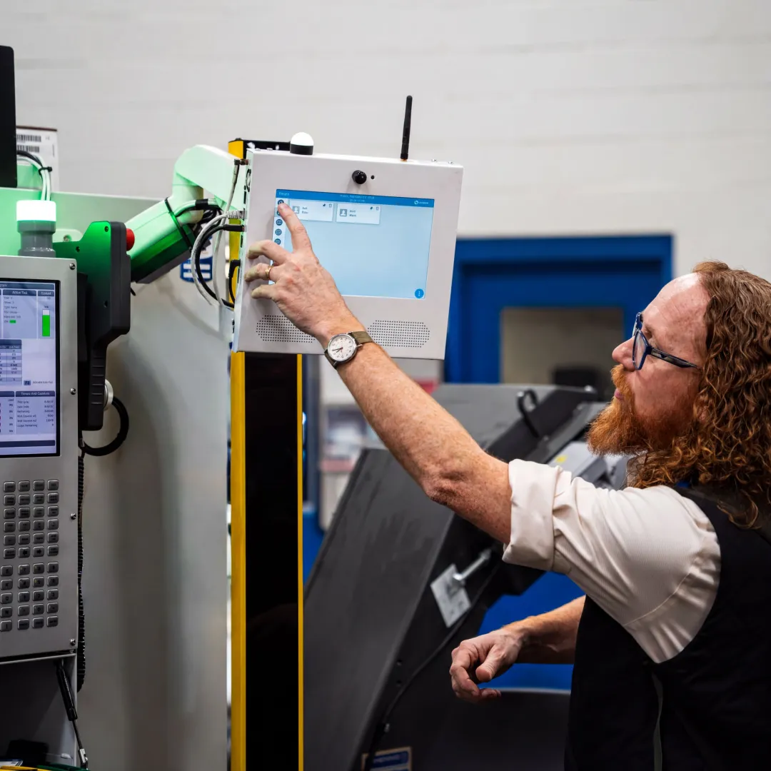 Operator using digital inspection checksheet at CNC machine