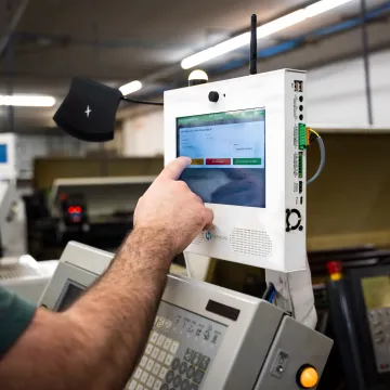 Operator reviewing live machine monitoring dashboard
