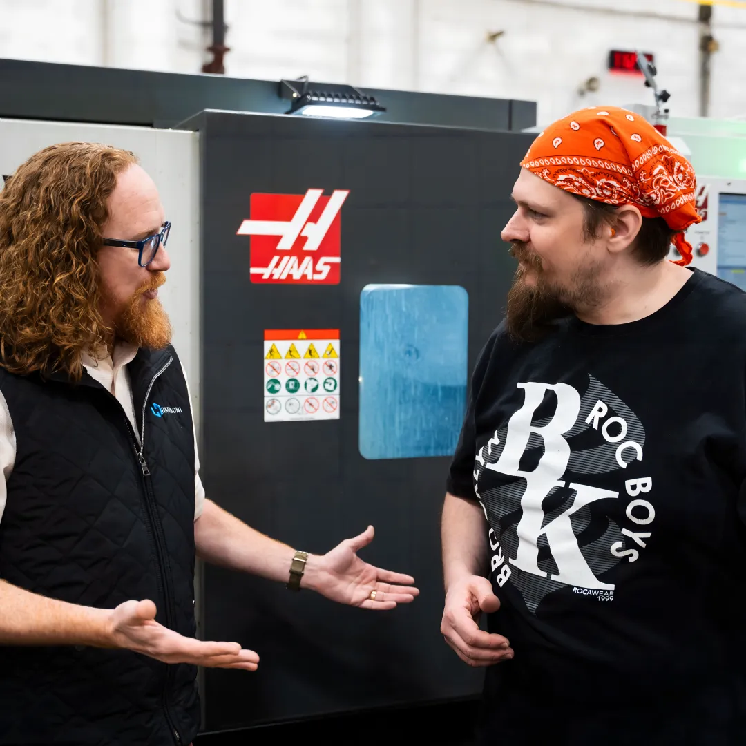 Operator reviewing digital work instructions at a CNC machine