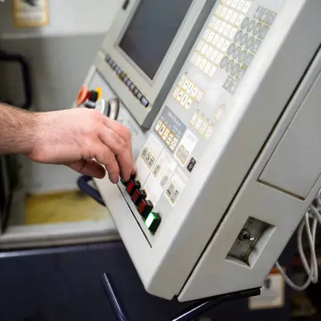 Operator reviewing real-time machine monitoring dashboard