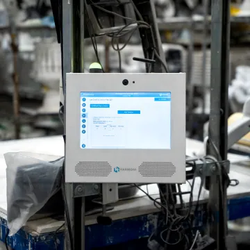 Manufacturing team reviewing shop floor dashboard
