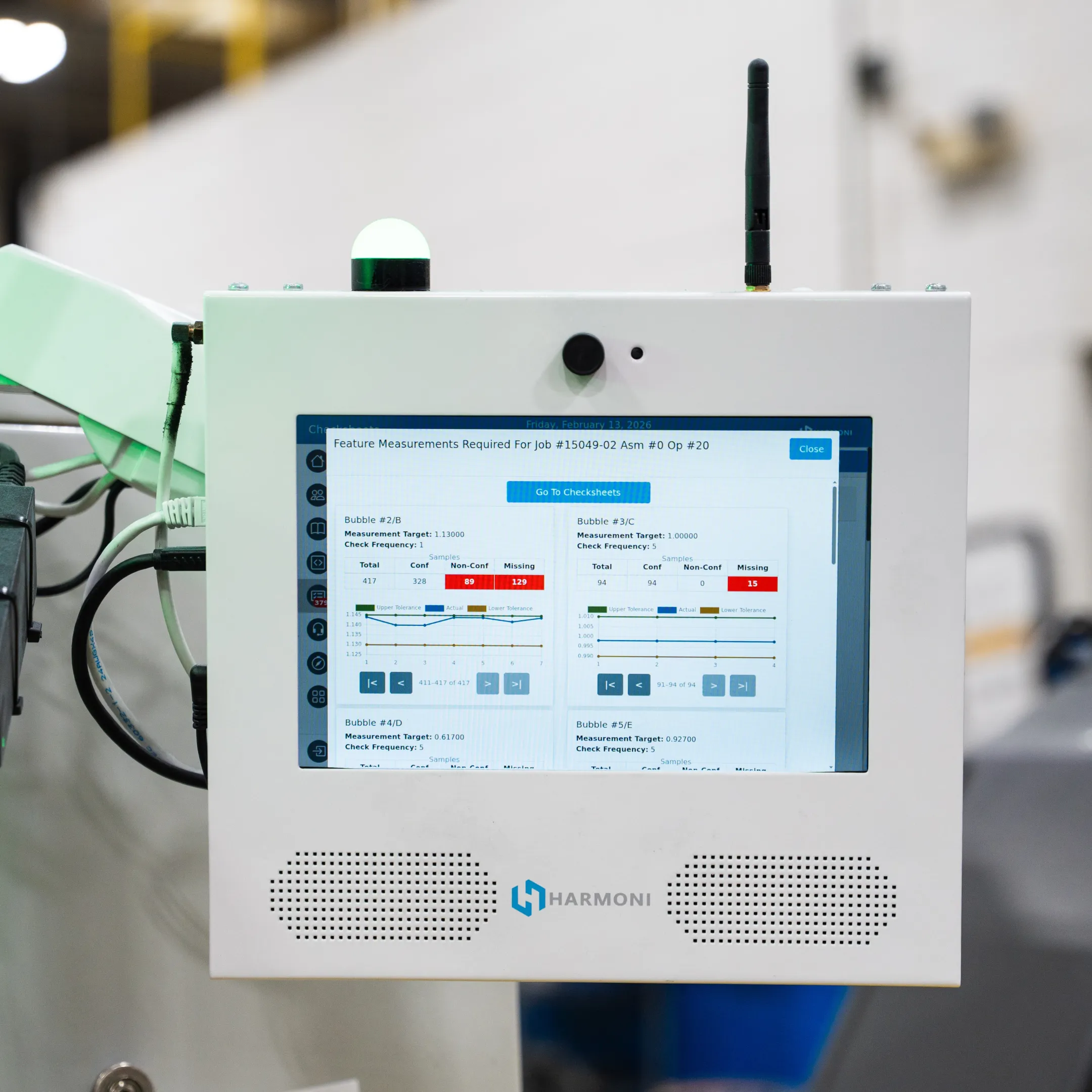 Digital production information displayed beside a CNC machine