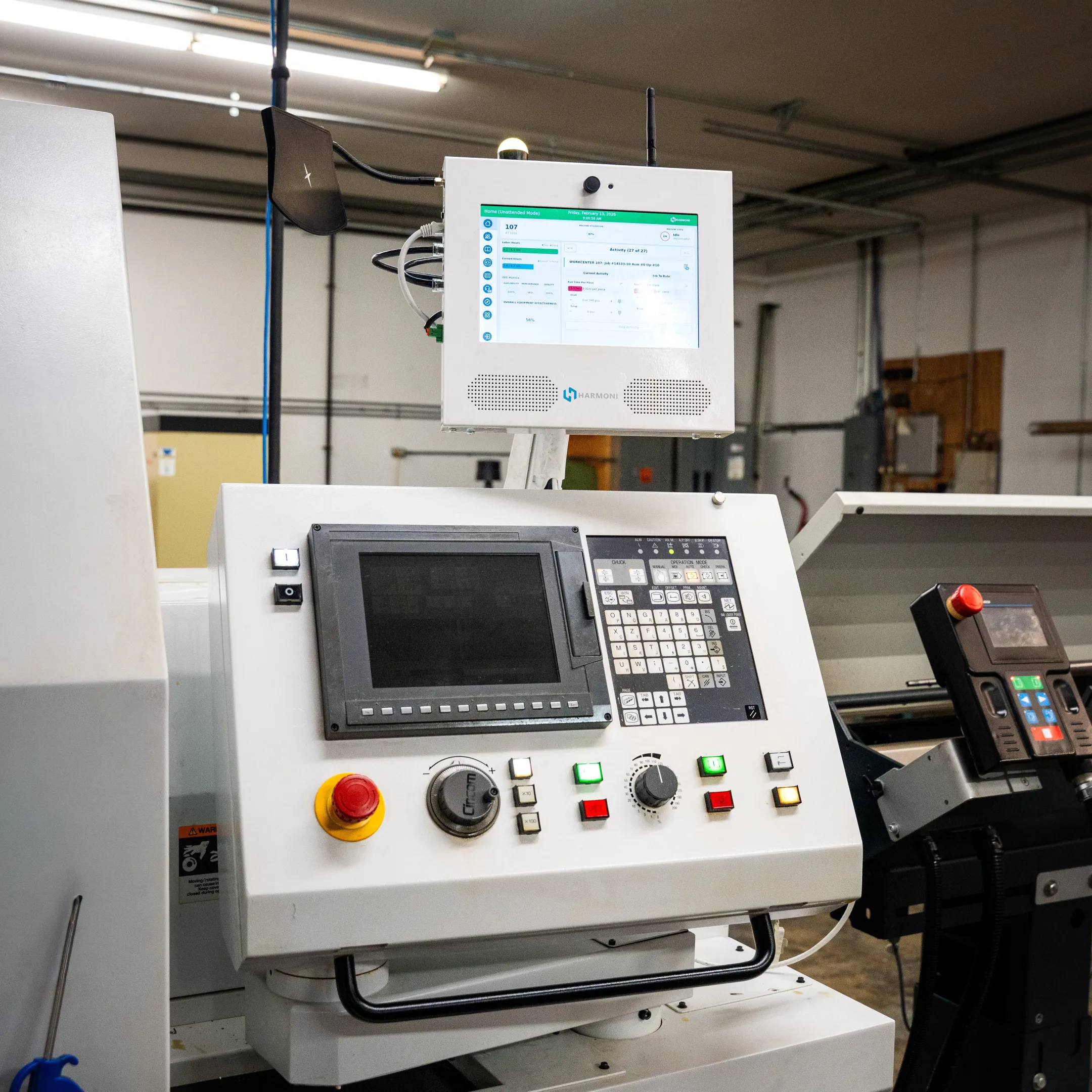 Engineer using machine monitoring software on shop floor