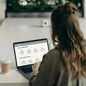 Employee reviewing elder care benefits on a laptop