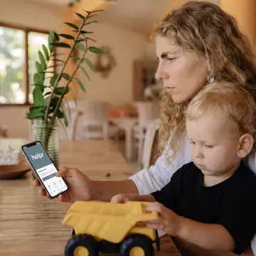 Parent and child using a care app at home