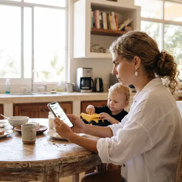 Parent reviewing childcare options on a phone