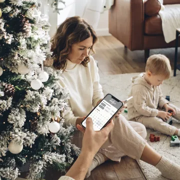 Parent using a childcare app during the holidays