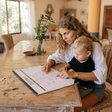 Parent and child planning holiday childcare at home