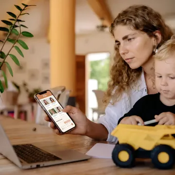 Working parent using family care app at home