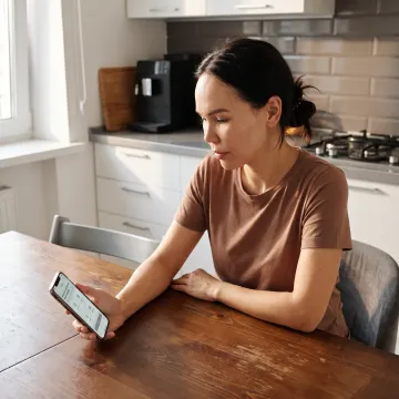 Parent reviewing family care options on a phone