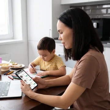 Parent reviewing child care options on phone