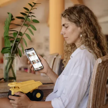 Working parent reviewing caregiver options on a phone