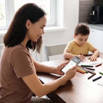 Working parent arranging care on a phone