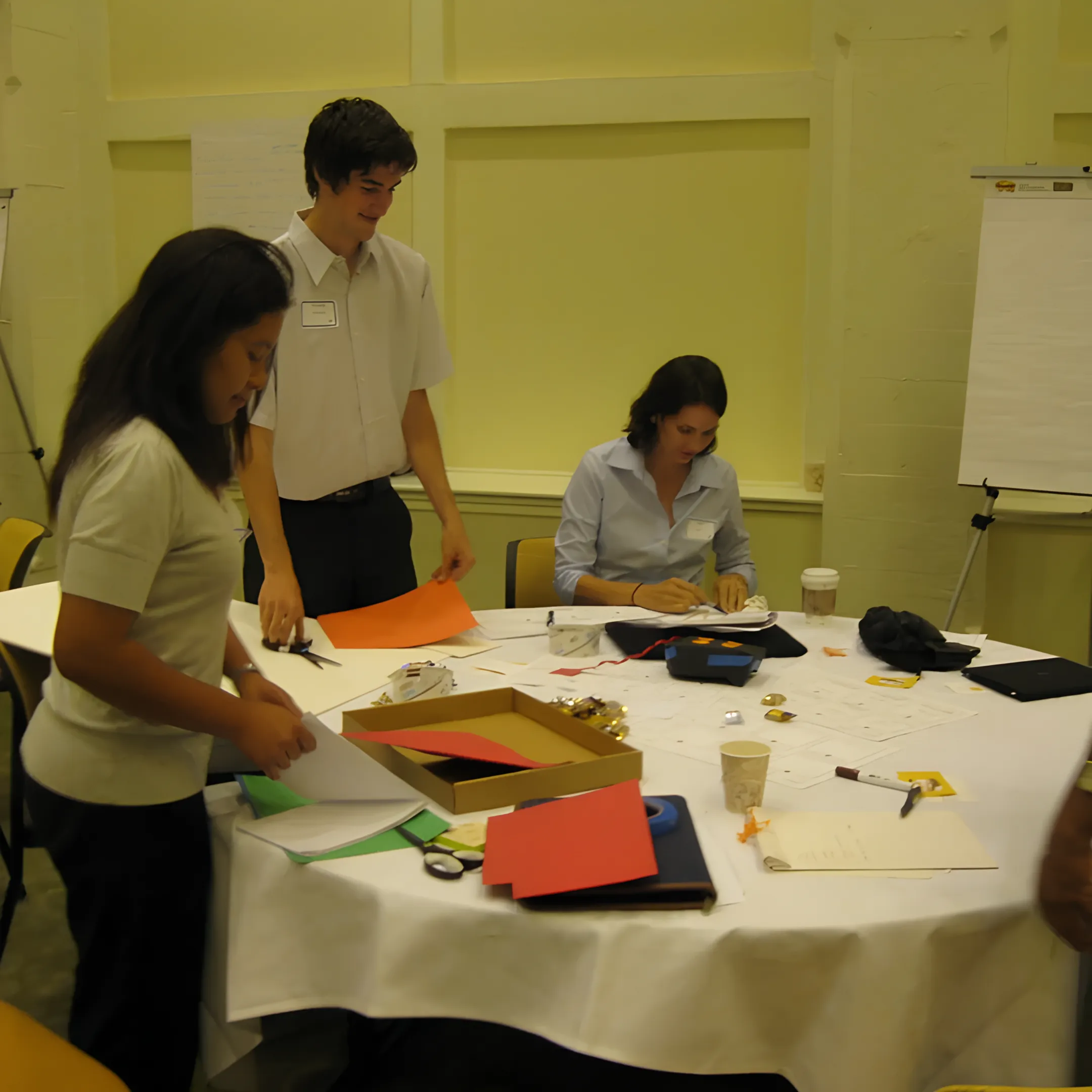 Design team discussing inclusive interior strategies around architectural drawings