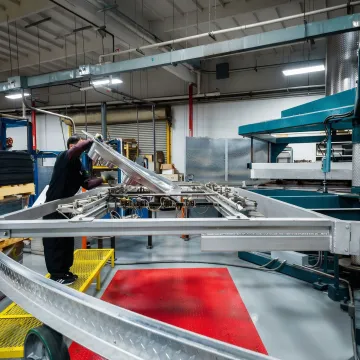 Thermoforming production mold being installed on industrial forming equipment