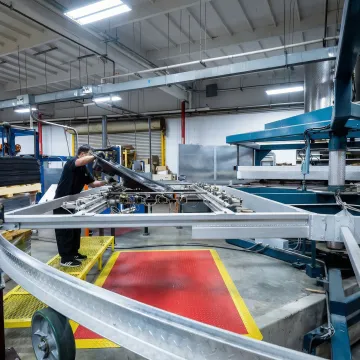 Industrial thermoforming machine heating and forming large plastic sheet into custom component