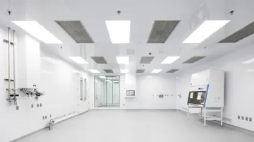 GMP cleanroom interior showing flush sprinkler heads coved wall junctions and sanitary pipe supports
