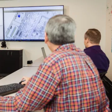 Cleanroom engineering team reviewing process plans
