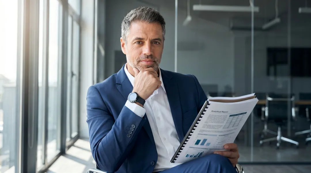Senior executive reading in-depth business thought leadership analysis on tablet