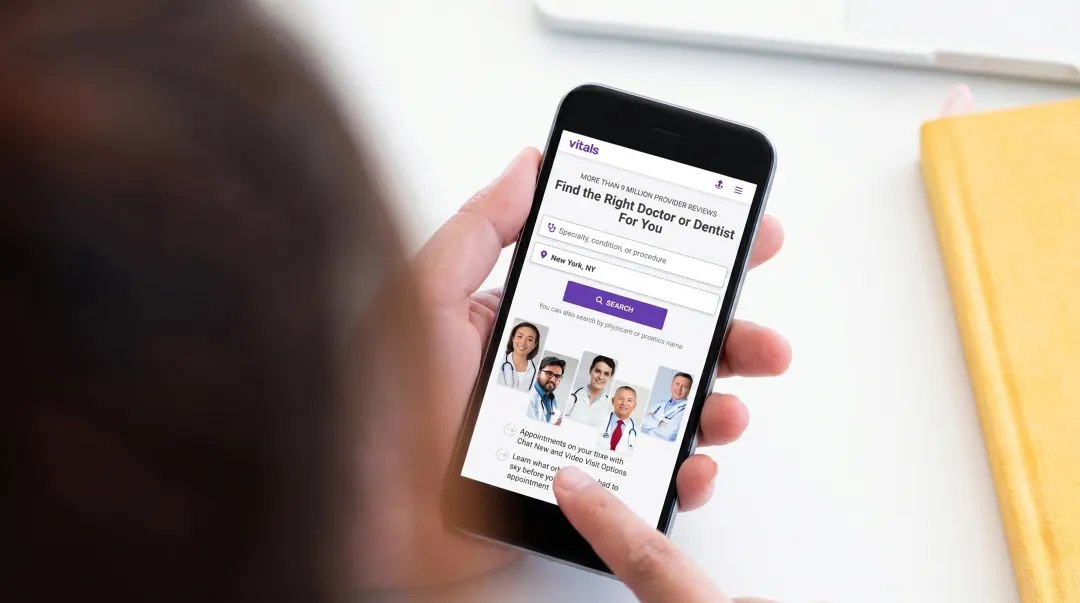 Patient searching for doctor reviews on smartphone with healthcare website visible