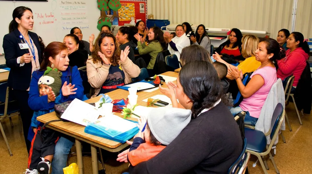 Pediatrician speaking to parents at a school community health event