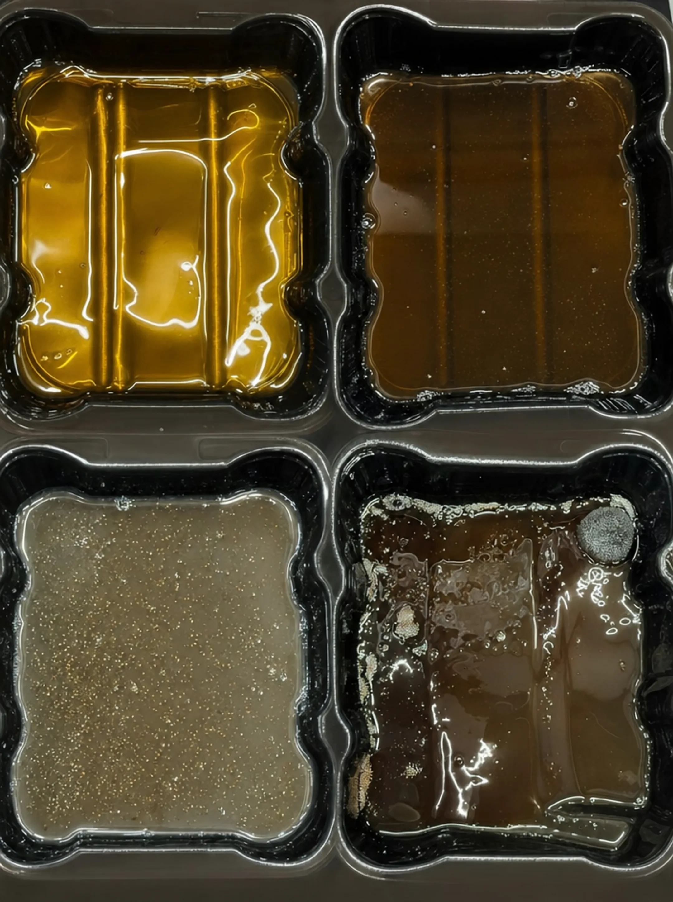 Industrial gearbox oil sample showing contamination and metal shavings