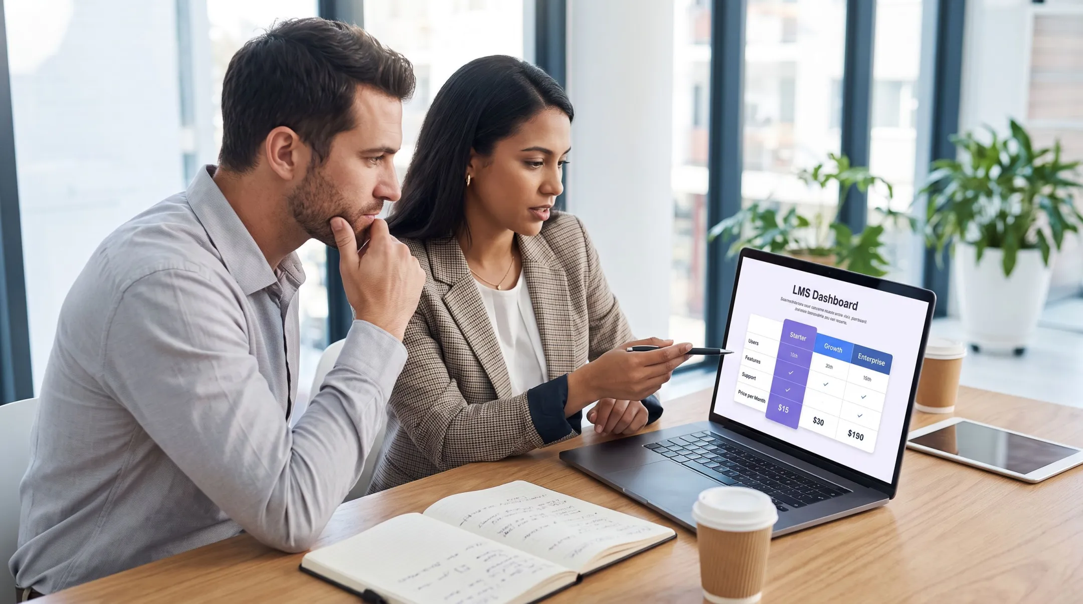 Business team evaluating LMS software dashboard on laptop screen