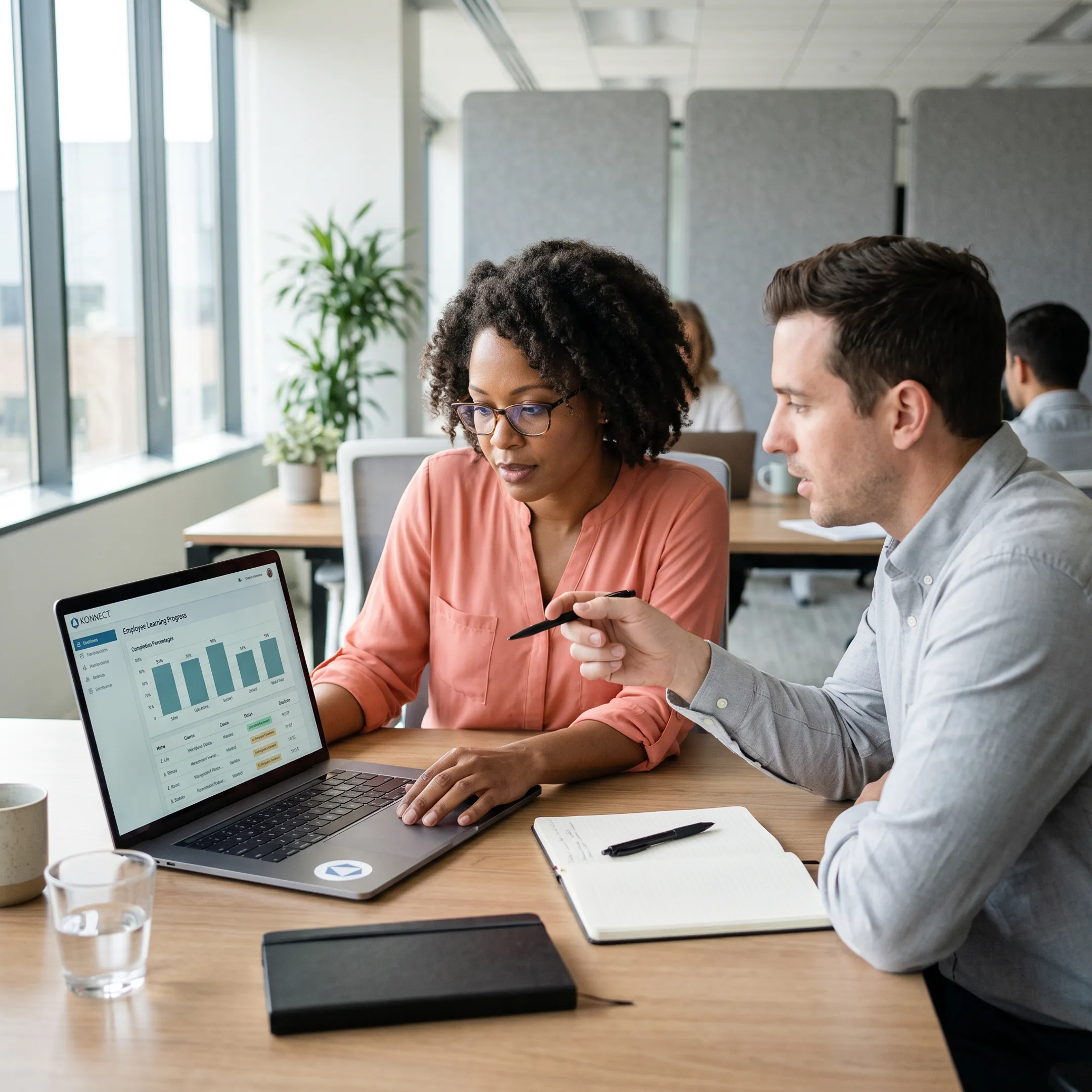 Manager reviewing employee learning progress on a laptop