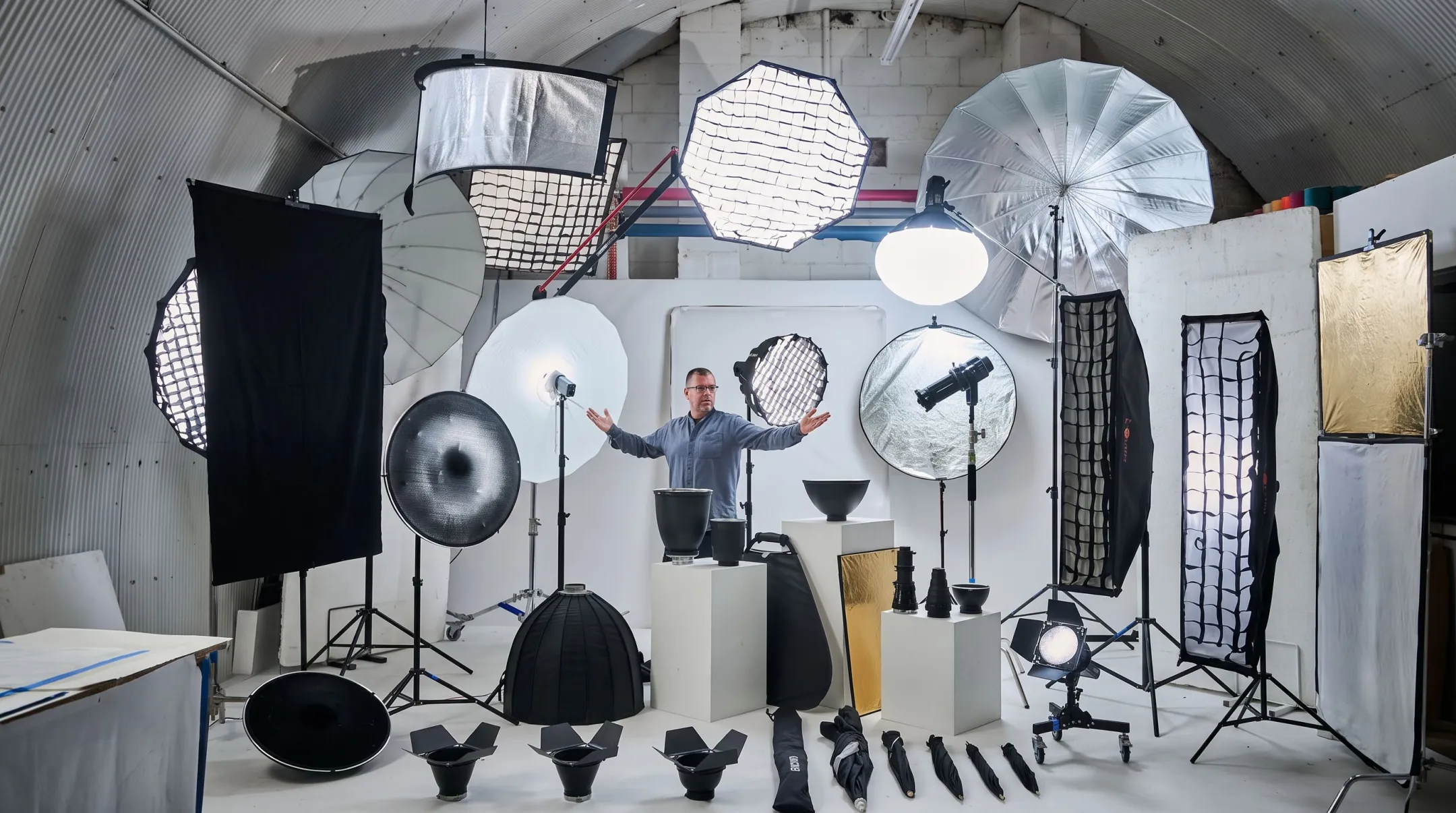Film set lighting equipment including softboxes flags and reflectors on stands