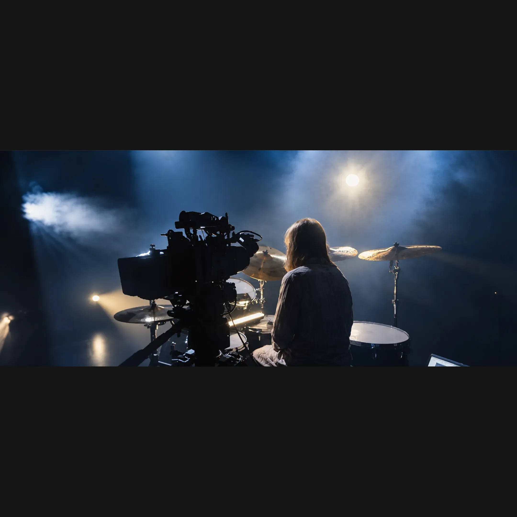 Director reviewing music video footage with an artist