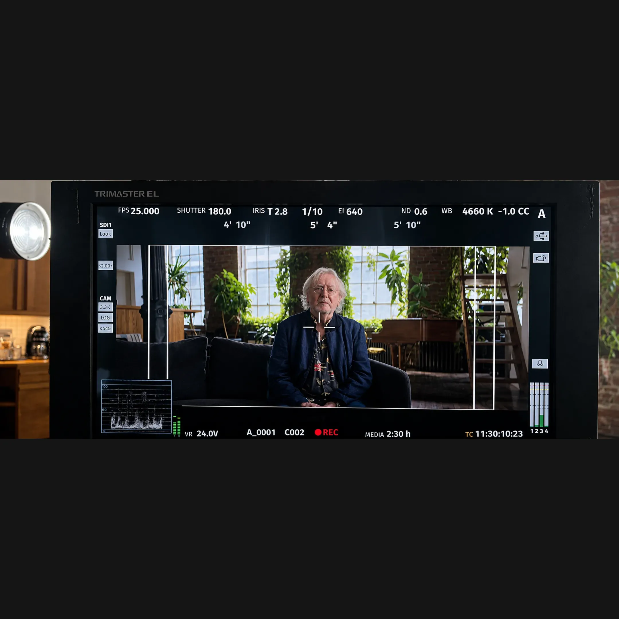 Producer and camera crew reviewing footage