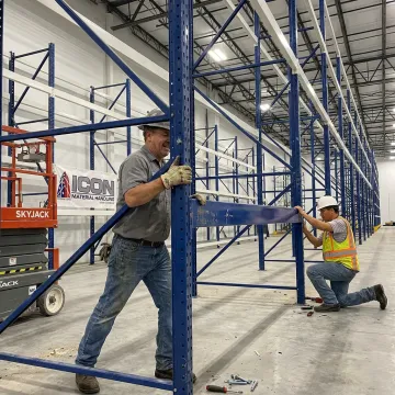 Technicians assembling warehouse pallet racks