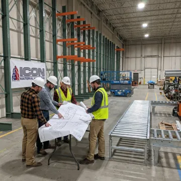 Warehouse setup team reviewing racking layout