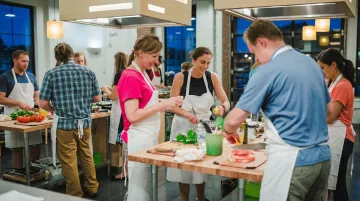 Corporate group participating in hands-on cooking class team building activity
