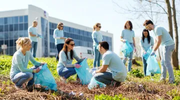 Corporate team volunteering together at community service project outdoors