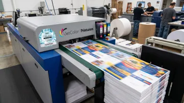 iJetColor high-speed press producing full-bleed variable-data print jobs