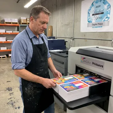 Operator inspecting full-color coin envelopes