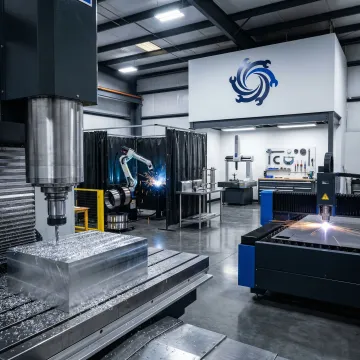 Integrated metal fabrication shop showing CNC machines, welding stations, and inspection equipment