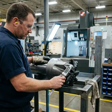 Machinist inspecting custom drill bit