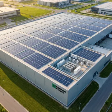 Modern commercial building with rooftop solar panels and energy management system