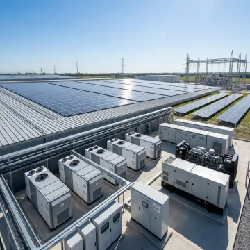 Onsite microgrid power generation system with solar panels and energy storage units at an industrial facility