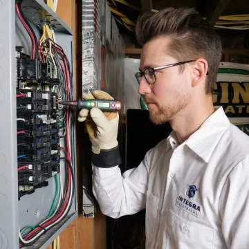 Electrician testing circuits after completing a panel rewiring job