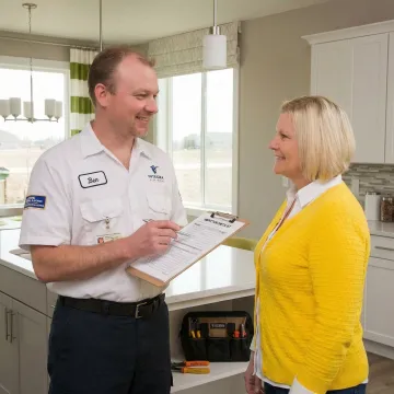 Electrician walking a homeowner through electrical inspection findings on a clipboard