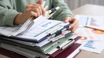 Stack of retirement account statements representing trillions in 401k assets