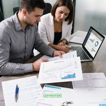 Investment fund team reviewing real estate-backed portfolio strategy