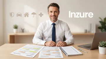 Insurance professional reviewing multiple policy documents side by side on desk