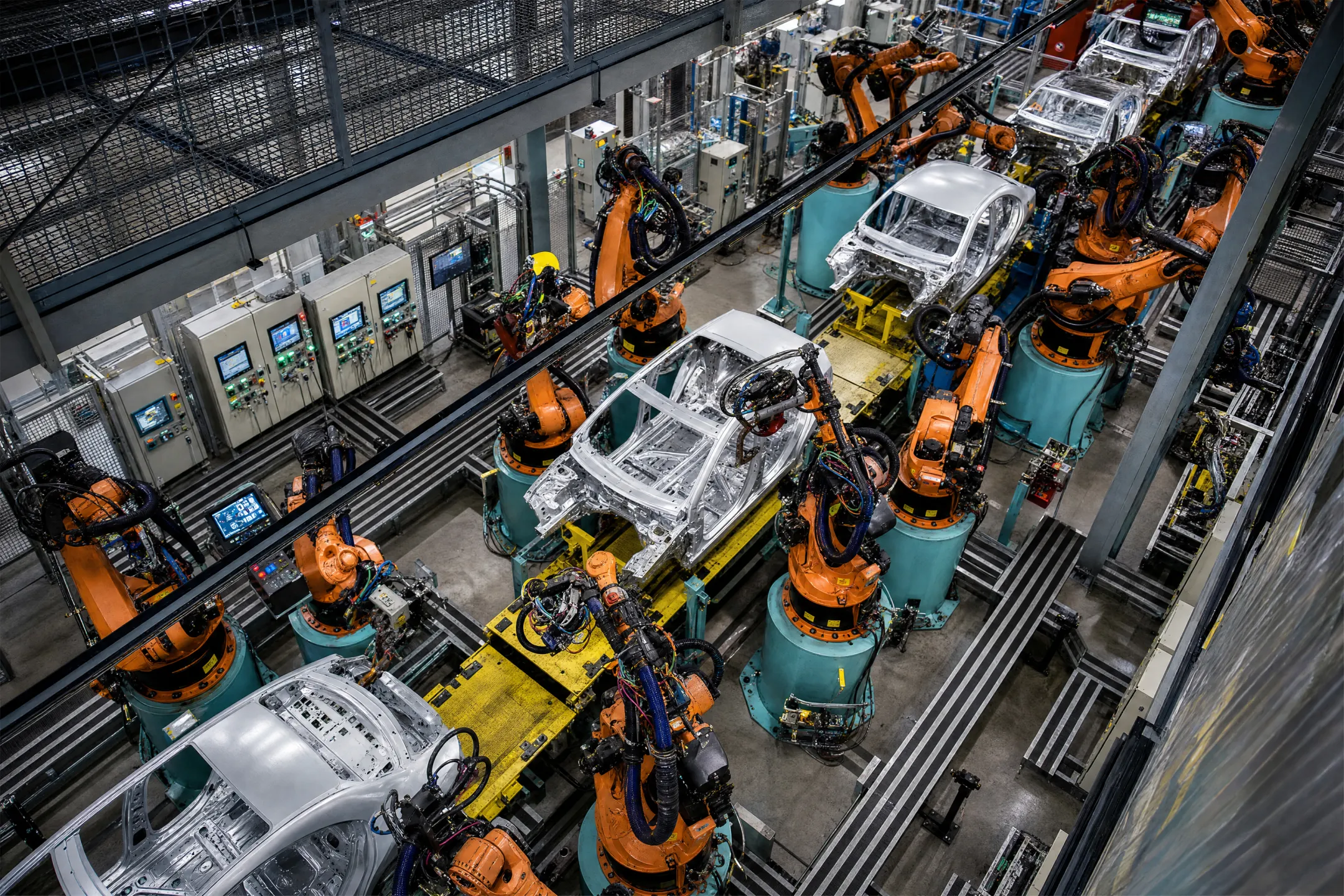 Industrial robot arms operating on automated manufacturing production line