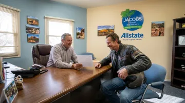 Jacobs Family Insurance agent consulting with motorcycle rider client in Santa Fe office