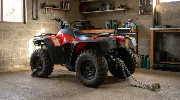 ATV secured with heavy-duty chain lock inside enclosed garage storage facility
